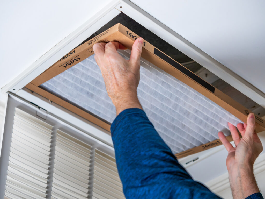 HVAC technician replacing a home air filter in Lodi