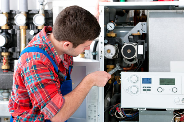 Heating technician repairing boiler controls in Lodi