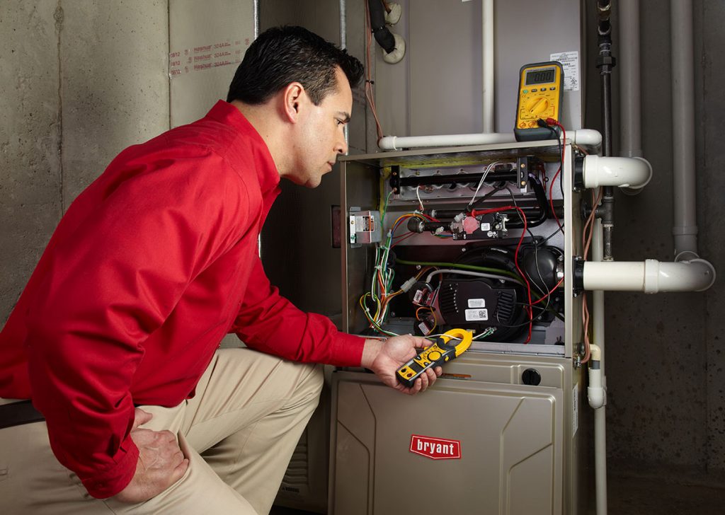 Heating technician diagnosing a furnace repair in Lodi