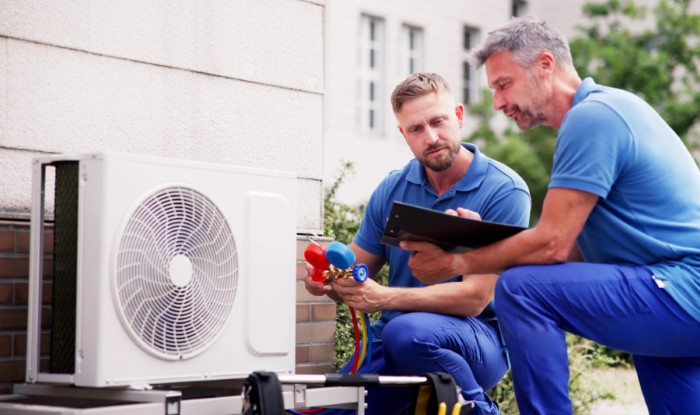 HVAC technicians installing an outdoor air conditioning unit in Lodi