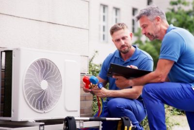 Outdoor AC Installation Lodi HVAC technicians installing an outdoor air conditioning unit in Lodi